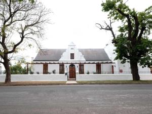 a large white building with a door in the middle at Adderley House Guest Accommodation in Robertson