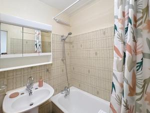 a bathroom with a sink and a shower curtain at Hello Menton in Menton +42 photos