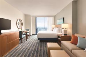 a hotel room with a bed and a television at Hyatt House Virginia Beach / Oceanfront in Virginia Beach
