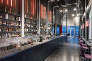 a bar with a lot of bottles of alcohol at nhow Frankfurt in Frankfurt