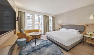 a hotel room with a bed and a couch and a table at Hyatt Regency London Blackfriars in London +103 photos