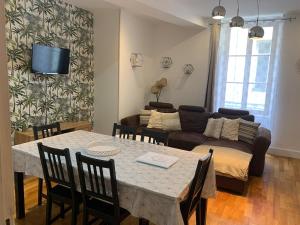 a living room with a table and a couch at La Motte Forte in Arnay-le-Duc
