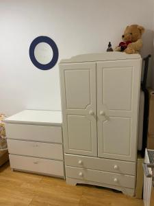 a white cabinet with a teddy bear sitting on top at 2 Double Bed Apartment Central London in London