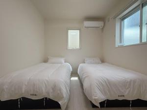 Postel nebo postele na pokoji v ubytování Sanmi 天下茶屋1号馆