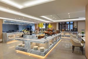 a lobby with a bar with chairs and tables at Ramada by Wyndham Urumqi Midong in Ürümqi +18 photos