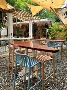 a wooden table and chairs under an umbrella at Kawayan Terrace - Boracay in Boracay