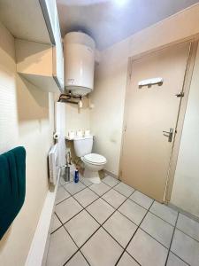 a small bathroom with a toilet and a door at L épicentre Gare d Amiens in Amiens +11 photos