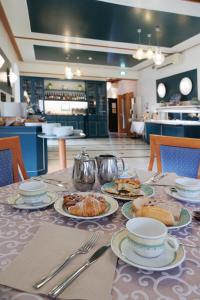 a table with plates of food on top of it at Hotel Villa Adriana in Monterosso al Mare