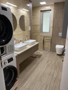 a bathroom with two sinks and a washing machine at Balatonkenese Sunshine Villa in Balatonkenese +41 photos