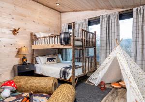 a bedroom with two bunk beds and a play tent at Luxury Gatlinburg Cabin, Heated Pool, Theater, Hot Tub in Gatlinburg +43 photos