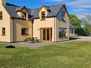 a house with a picnic table in front of it at Beacon View, Church Cross, Skibbereen, County Cork in Church Cross