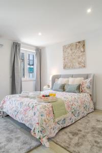 a bedroom with a large bed with a tray on it at HostWise - Modern & Bright Studio in Porto