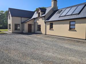 a house with solar panels on the roof at Beacon View, Church Cross, Skibbereen, County Cork in Church Cross