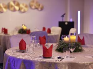 a table with red napkins and wine glasses on it at Minamisenri Crystal Hotel - Vacation STAY 78139v in Suita