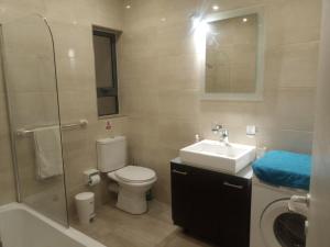 a bathroom with a toilet and a sink and a shower at Comfortable vacation home with great views in Mellieħa +27 photos