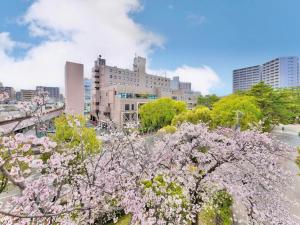 a view of a city withakura trees and buildings at Minamisenri Crystal Hotel - Vacation STAY 78162v in Suita
