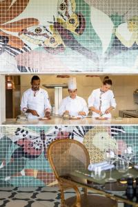 a group of three chefs standing in a kitchen at Legend Hill Resort and Spa in Rivière Noire +122 photos
