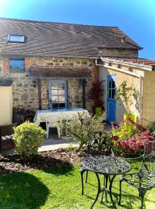 a house with a table and chairs in the yard at La Miette in La Celle-sous-Gouzon +12 photos
