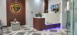 UmargāmHotel V Point的大堂设有柜台和墙上的标志