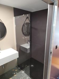 a bathroom with a sink and a shower at Biała Perła Residence Czarna Góra in Sienna +9 photos