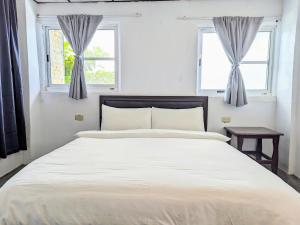 A bed or beds in a room at A-Lang Homestay