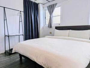 A bed or beds in a room at A-Lang Homestay