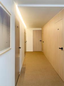 an empty hallway with two doors and a room with a hallway at OFF STAY, hotel in Seoul - 10m from Airport, 8m to Subway in Seoul