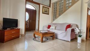 a living room with a couch and a tv and a table at New Villa Dubai - Okrug Gornji,Trogir, Hrvatska in Trogir