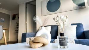 a table with a blue couch and vases on it at exclusive apartment with AC and parking in Santiago