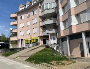 a large apartment building with a staircase in front of it at Apartman Marly in Krapinske Toplice