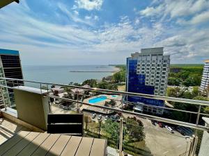 a view of the ocean from a balcony of a building at Aky&Suki Sea View Apartments in Olimp