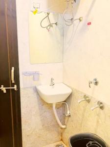 a bathroom with a sink and a mirror at Ritngen Home Stay in Mylliem