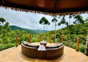 a hot tub on a deck with a view of the mountains at Forest 101 in Infanta