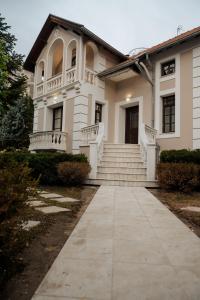 a white house with a porch and a walkway at Villa Emerald in Florina