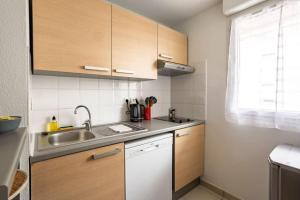 a kitchen with a sink and a counter top at Le Sévigné - Cosy et calme - balcon et parking in Cesson-Sévigné +6 photos