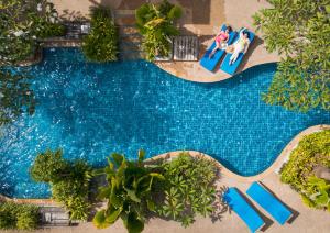 an overhead view of a swimming pool with people sitting on chairs by it at Railay Village Resort in Railay Beach