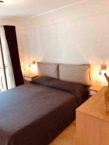 a bedroom with a bed and two lamps on two tables at A casa dei Sasso vista mare mozzafiato in Positano