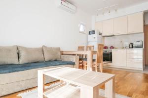 a living room with a couch and a table at Nest in Kravlja