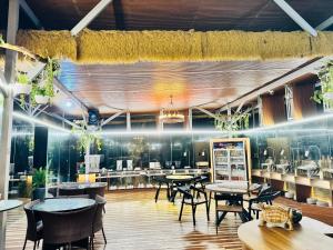 a restaurant with tables and chairs in a room at Forest 101 in Infanta
