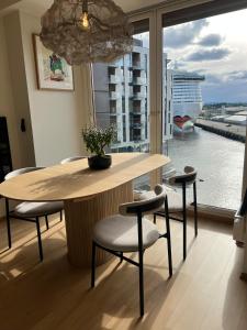 a table and chairs with a view of a cruise ship at Spacious apartment with sea-view and sunset in Oslo