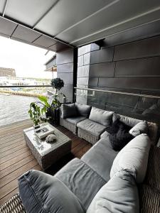 a living room with a couch and a table at Spacious apartment with sea-view and sunset in Oslo