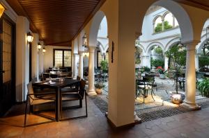 a patio with a table and chairs in a building at Eurostars Conquistador in Córdoba