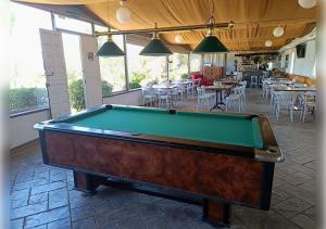 a pool table in a room with tables and chairs at EL PUEBLO III -venga al pueblo- in Calañas