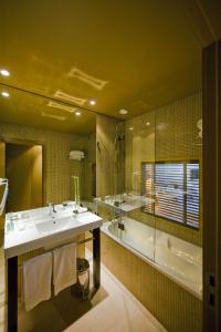 a bathroom with a sink and a shower and a tub at Pestana Palácio do Freixo, Pousada & National Monument - The Leading Hotels of the World in Porto