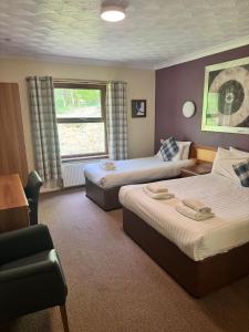a hotel room with two beds and a window at Rob Roy Hotel in Aberfoyle +22 photos