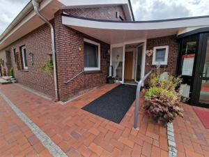 a brick house with a brick driveway at Ferienwohnung "Fehn-Moor" 95156 in Rhauderfehn