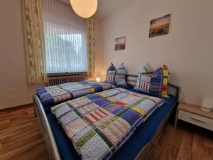 a bedroom with two beds and a window at Ferienwohnung "Fehn-Moor" 95156 in Rhauderfehn