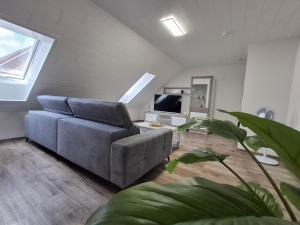 a living room with a couch and a tv at Ferienwohnung "Haus Peter" 65357 in Moormerland