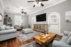 a living room with a couch and a tv at Blue Gumbo Gorgeous and Located a Few Minutes Walk to Beach in Galveston