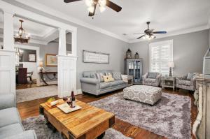 a living room with a couch and a table at Blue Gumbo Gorgeous and Located a Few Minutes Walk to Beach in Galveston
